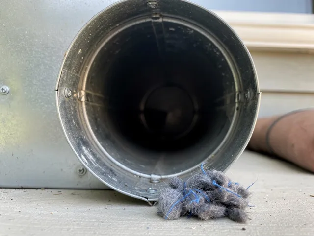 Miami Beach Dryer Vent Cleaning technician using specialized equipment to clear severe dryer vent blockage in Miami Beach